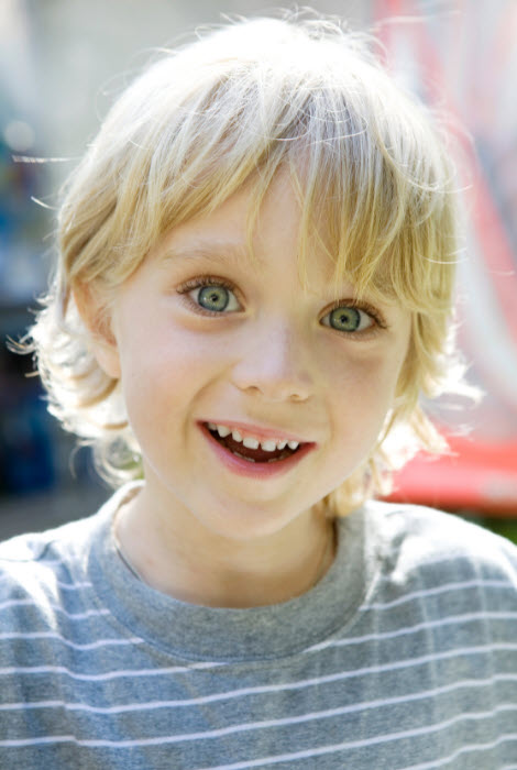 Blond-haired child with a big smile